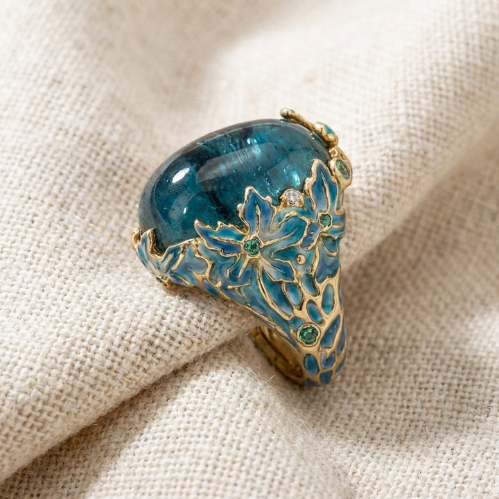 Elegant Gold Floral Ring Featuring a Blue Gemstone