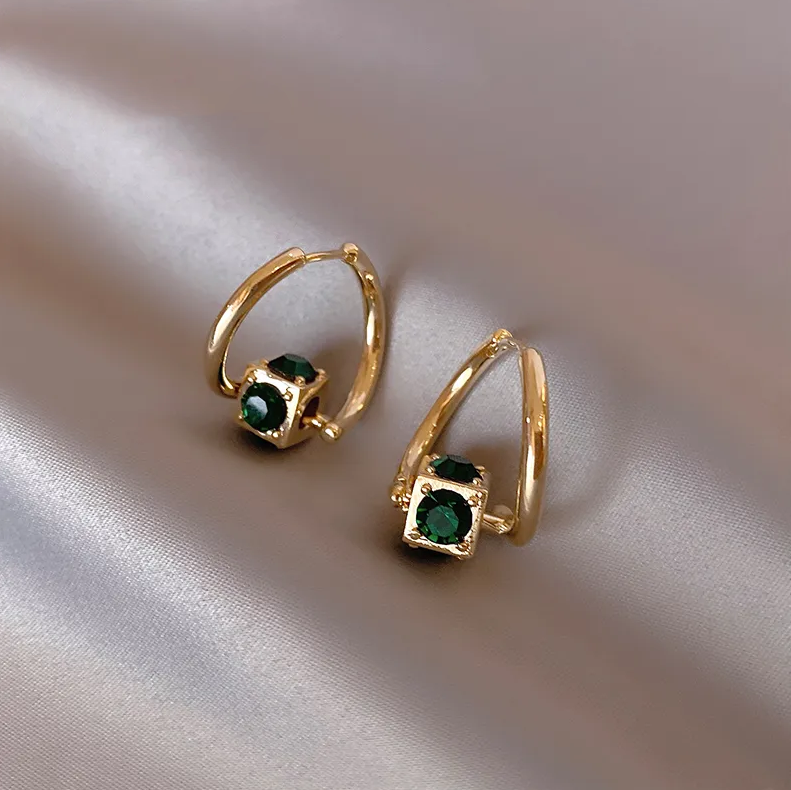 Elegant Gold Earrings Featuring Green Highlights
